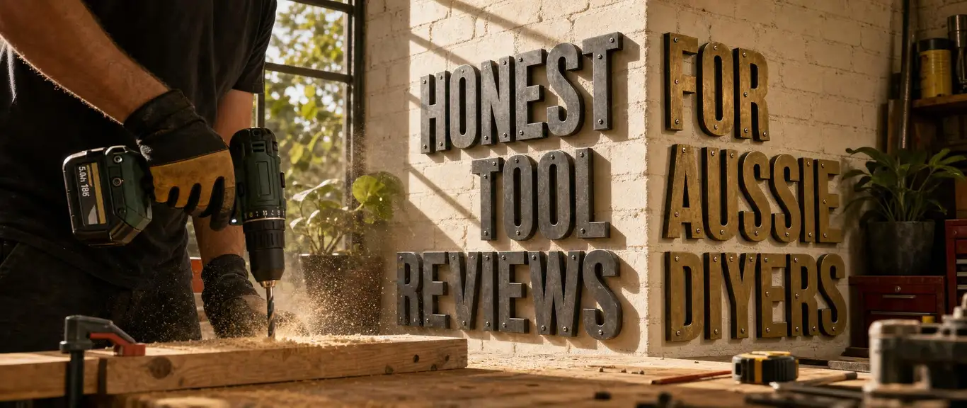 Honest tool reviews for Aussie DIYers — the tagline in metal letters on a workshop wall, someone drilling at a bench